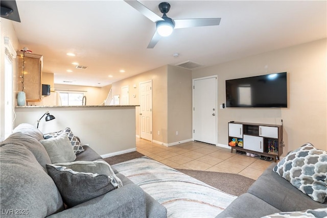 living area with light tile patterned floors, recessed lighting, a ceiling fan, visible vents, and baseboards