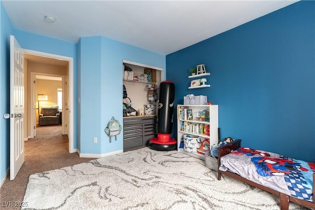 carpeted bedroom featuring baseboards