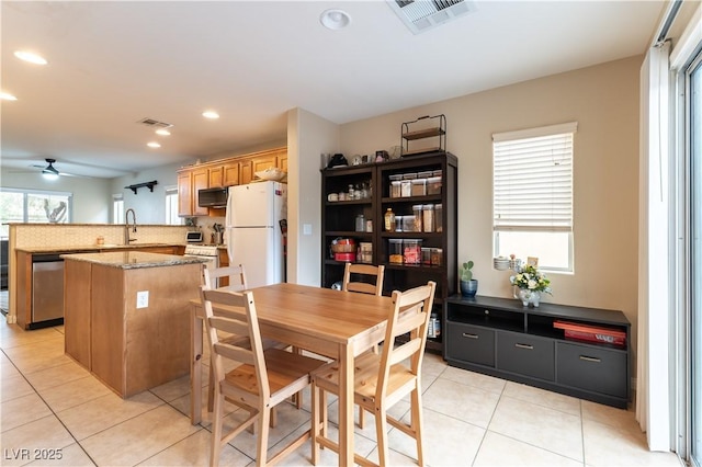 dining room with light tile patterned floors, visible vents, a ceiling fan, and recessed lighting