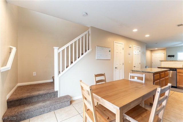 dining room featuring recessed lighting, visible vents, light tile patterned flooring, baseboards, and stairs