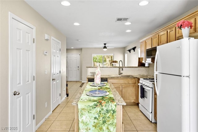 9527 Havasu Canyon Ave, Las Vegas, NV 89166 - kitchen with white appliances, a sink, light tile patterned floors, a peninsula, and a kitchen island