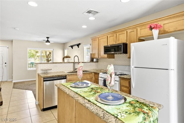 9527 Havasu Canyon Ave, Las Vegas, NV 89166 - kitchen featuring appliances with stainless steel finishes, a peninsula, backsplash, a ceiling fan, and light tile patterned flooring
