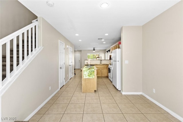 9527 Havasu Canyon Ave, Las Vegas, NV 89166 - kitchen featuring white appliances, light tile patterned flooring, a center island, recessed lighting, and baseboards