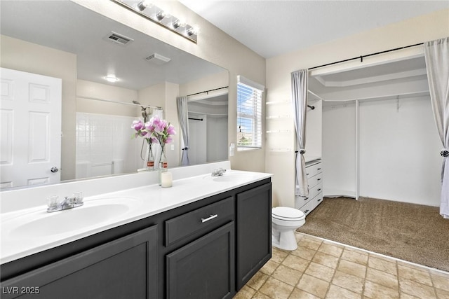 9527 Havasu Canyon Ave, Las Vegas, NV 89166 - bathroom with double vanity, toilet, a shower, and a spacious closet