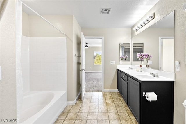 9527 Havasu Canyon Ave, Las Vegas, NV 89166 - bathroom featuring double vanity, ceiling fan, shower / bathtub combination, baseboards, and stone finish floors