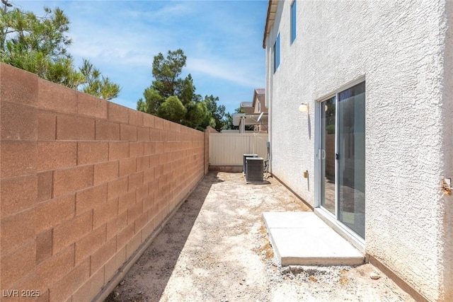9527 Havasu Canyon Ave, Las Vegas, NV 89166 - fenced backyard featuring cooling unit and a patio