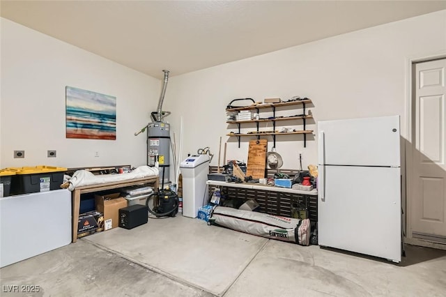 garage featuring water heater and white fridge