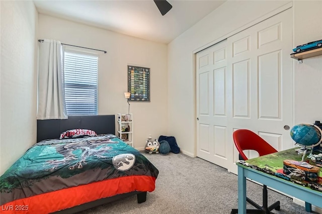 carpeted bedroom with ceiling fan and a closet