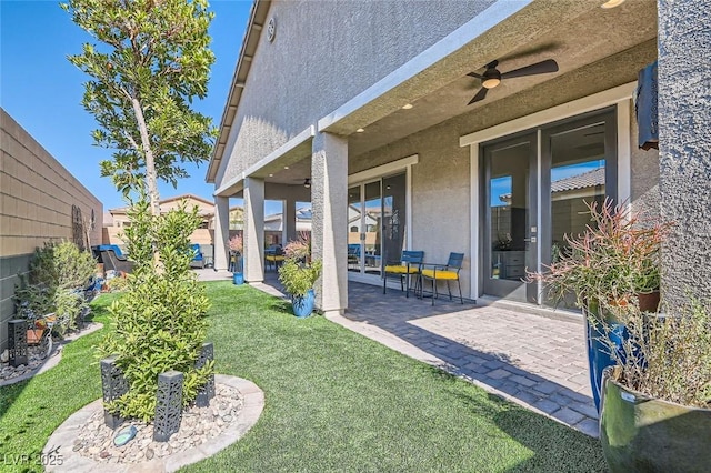 view of yard with ceiling fan and a patio