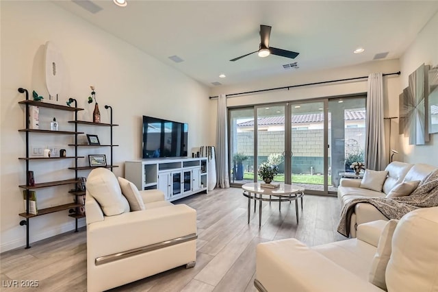 living room with ceiling fan and light wood-type flooring