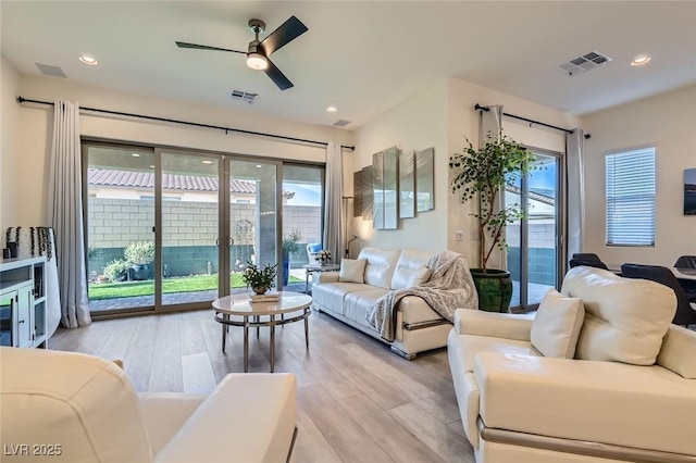 living room with ceiling fan and light hardwood / wood-style floors