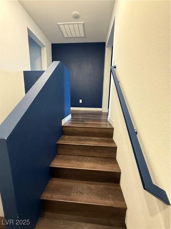 stairs featuring hardwood / wood-style flooring