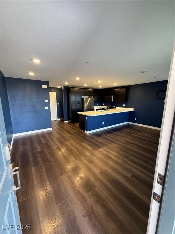 kitchen featuring a kitchen island, dark hardwood / wood-style floors, and appliances with stainless steel finishes