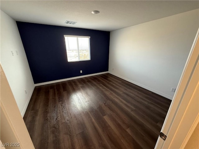 unfurnished room featuring dark hardwood / wood-style flooring