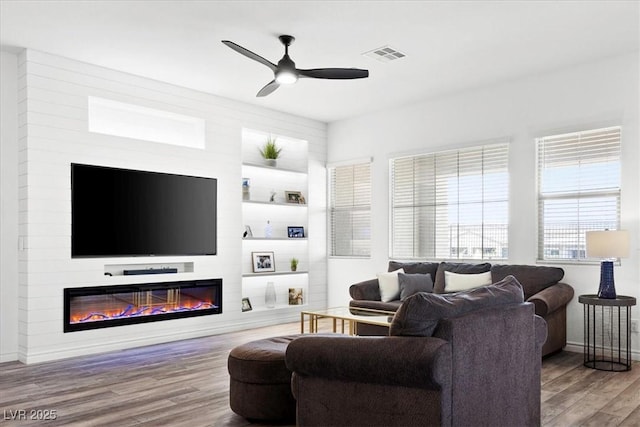 living room with hardwood / wood-style flooring and ceiling fan