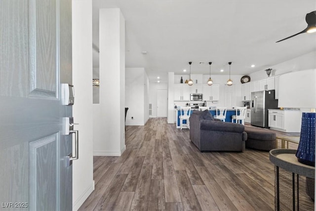 living room featuring hardwood / wood-style flooring and ceiling fan