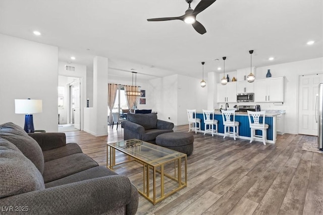 living room featuring hardwood / wood-style flooring and ceiling fan