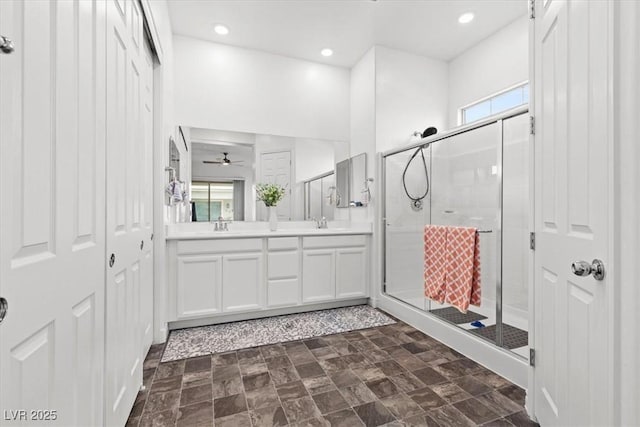 bathroom featuring vanity, ceiling fan, and walk in shower