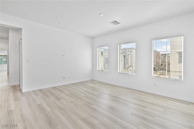 spare room with light hardwood / wood-style flooring