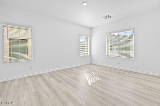 spare room with light wood-type flooring