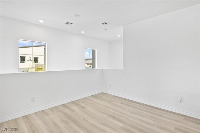 spare room featuring light wood-type flooring