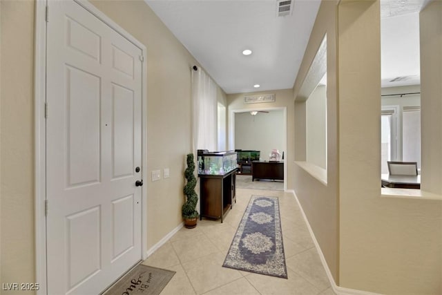 hall with light tile patterned floors