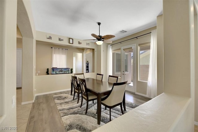 dining space with hardwood / wood-style floors and ceiling fan