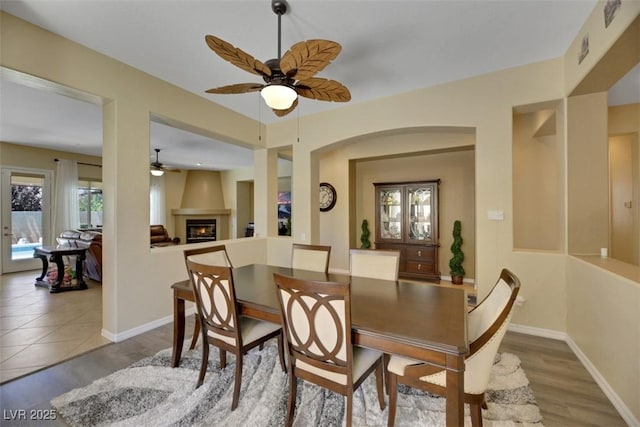 dining space with hardwood / wood-style floors and ceiling fan