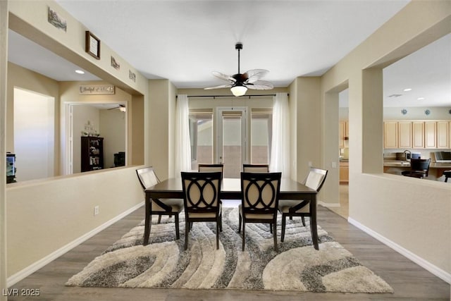 dining space with dark wood-type flooring and ceiling fan