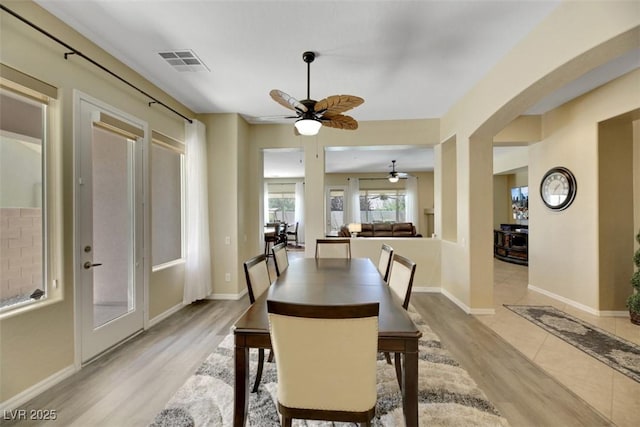 dining area with ceiling fan and light hardwood / wood-style flooring