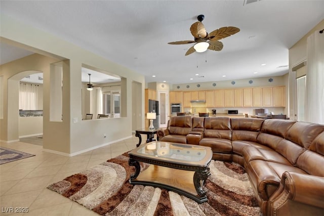 living room with light tile patterned floors and ceiling fan