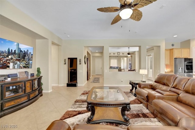 living room featuring light tile patterned floors and ceiling fan