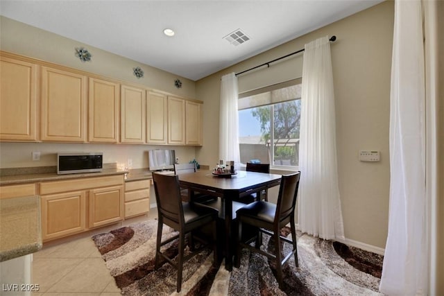 dining area featuring light tile patterned floors