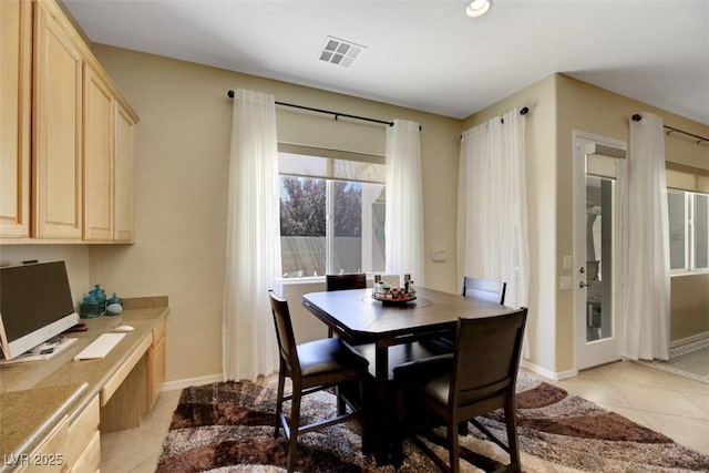 dining area with light tile patterned floors