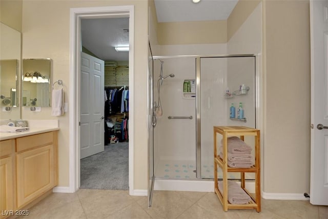 bathroom with tile patterned floors, vanity, and a shower with shower door