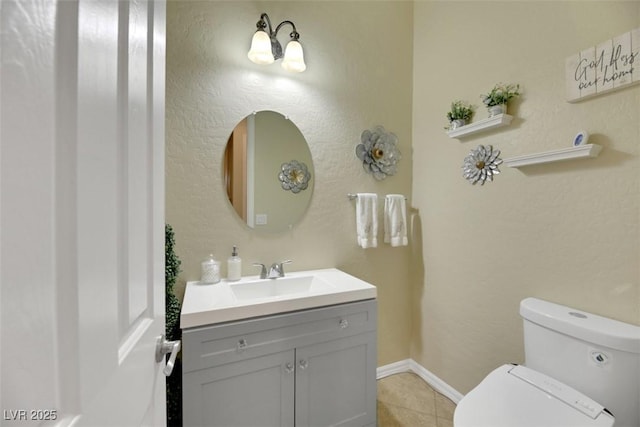 bathroom featuring vanity, tile patterned flooring, and toilet