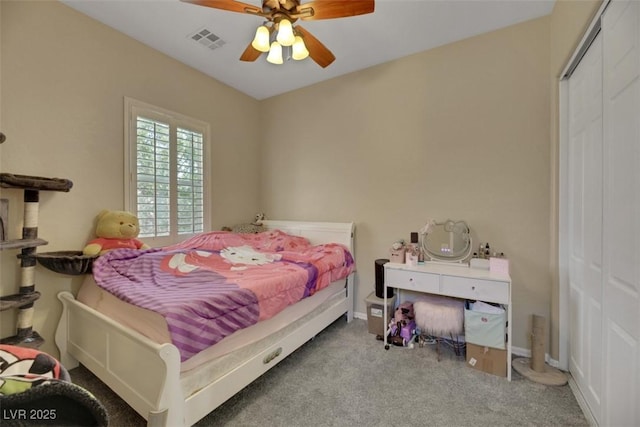 carpeted bedroom with a closet and ceiling fan