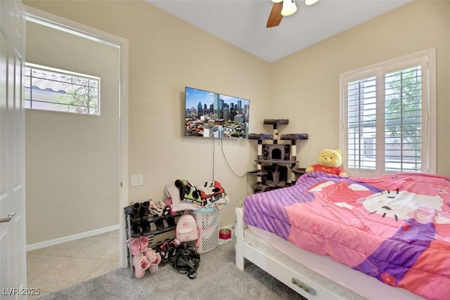 bedroom with ceiling fan and light tile patterned floors