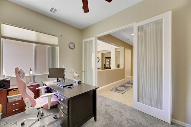 tiled office featuring ceiling fan