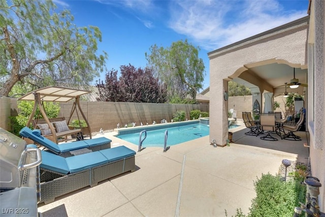 view of pool with a patio and ceiling fan