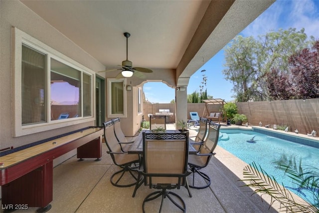 view of patio with a fenced in pool and ceiling fan