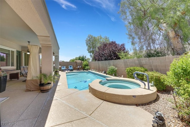 view of pool with a patio and an in ground hot tub