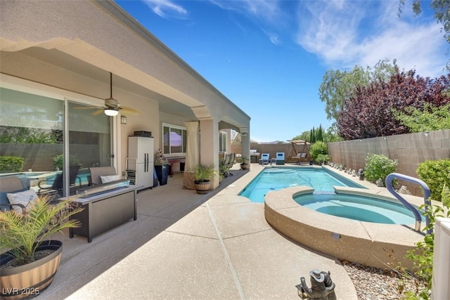 view of swimming pool featuring a patio area, ceiling fan, and an in ground hot tub