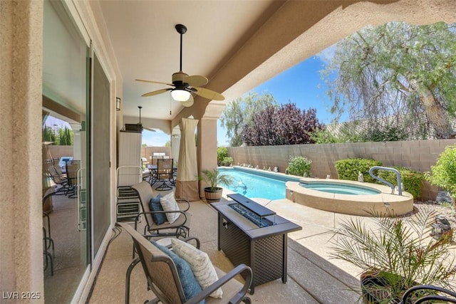 view of patio featuring ceiling fan and a swimming pool with hot tub