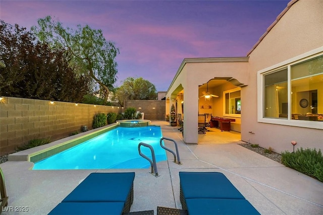 pool at dusk featuring a patio area