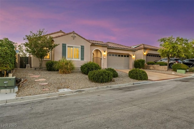 mediterranean / spanish-style home featuring a garage