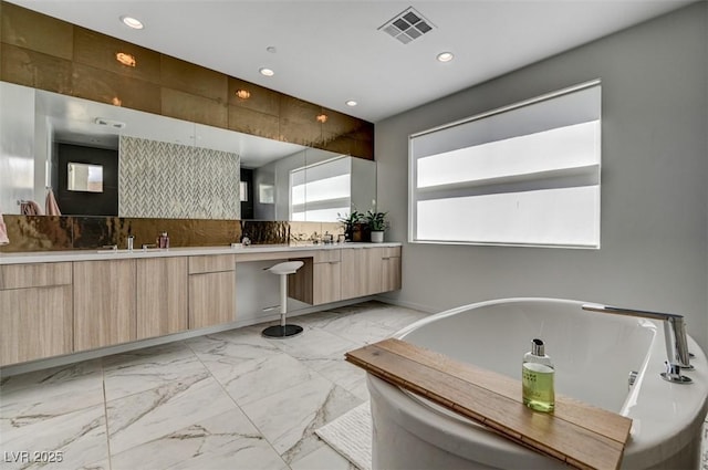 full bathroom featuring marble finish floor, double vanity, recessed lighting, visible vents, and decorative backsplash