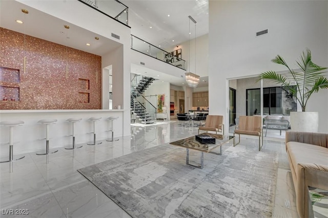 living area featuring marble finish floor, stairway, visible vents, and recessed lighting