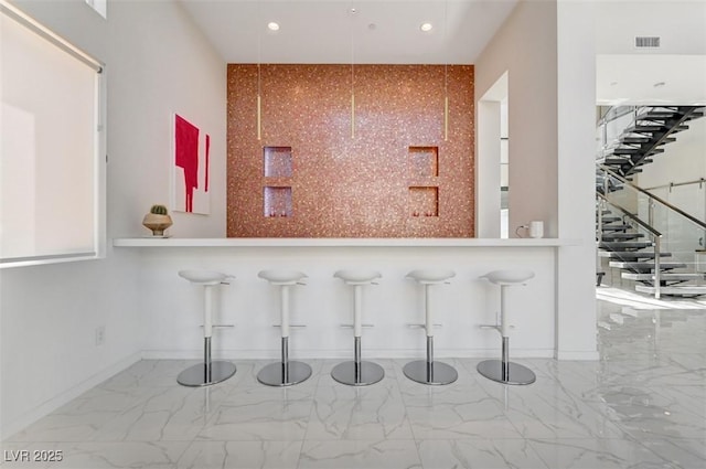 bar with baseboards, marble finish floor, visible vents, and recessed lighting