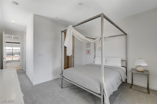 bedroom featuring baseboards and light colored carpet